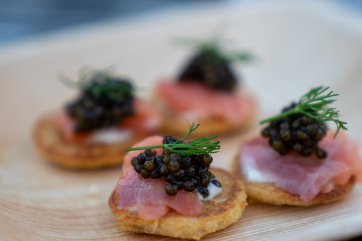 caviar on brown bread with green leaves