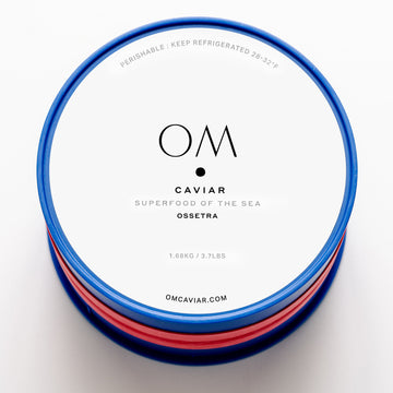 Tin of Ossetra caviar with white label and blue rim, branded OM Caviar, weighing 1.68 kg or 3.7 lbs.