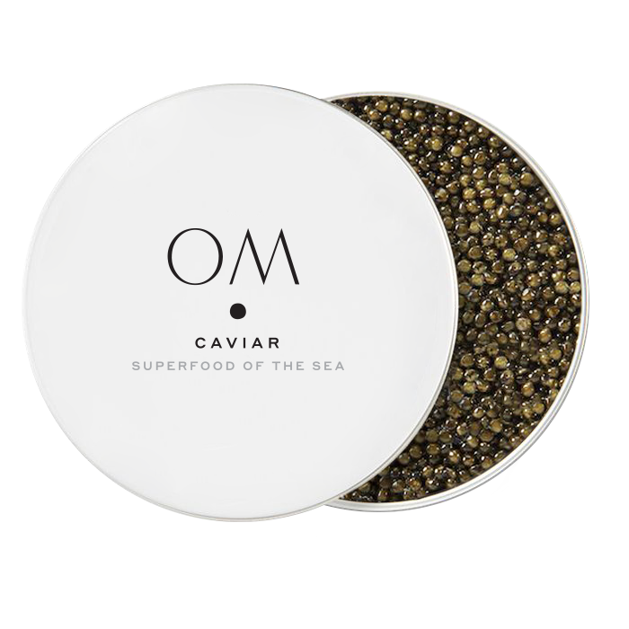 Open tin of OM Caviar Ossetra with medium-sized dark brown and golden roe, showcasing premium gourmet seafood product.